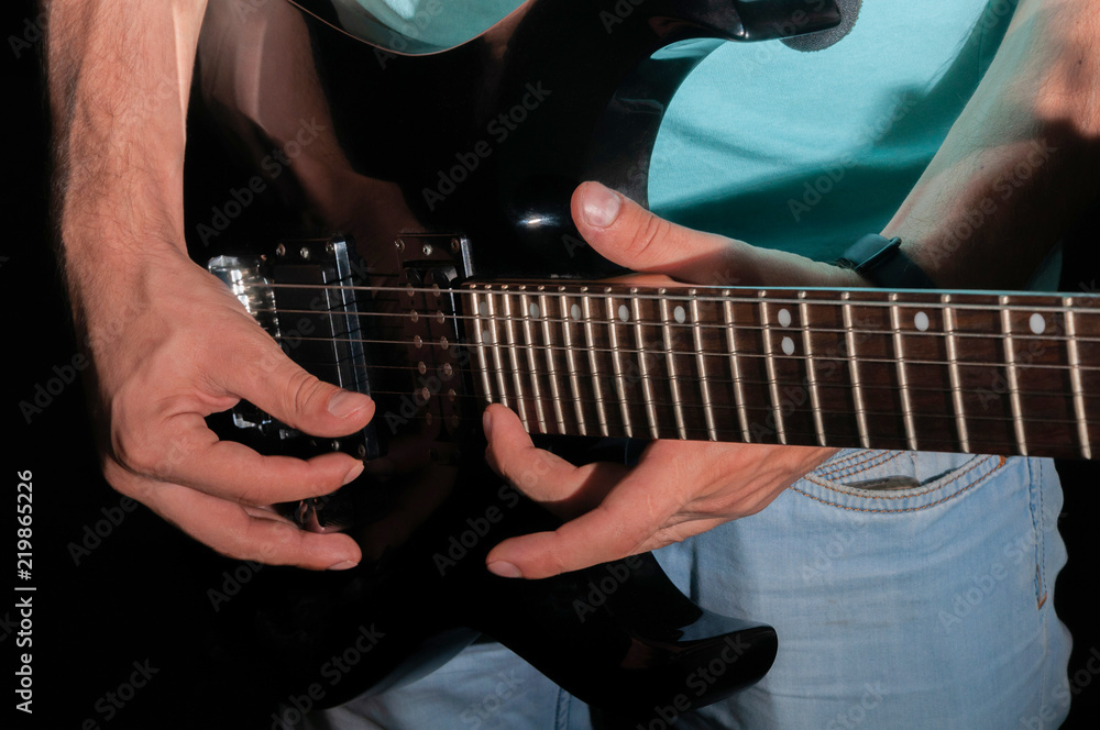 Fototapeta premium Man playing electric guitar, close-up
