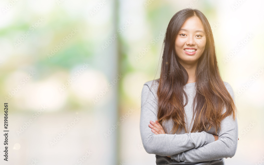 Young asian woman over isolated background happy face smiling with crossed arms looking at the camera. Positive person. Young asian woman over isolated background happy face smiling with crossed arms looking at the camera. Positive person.