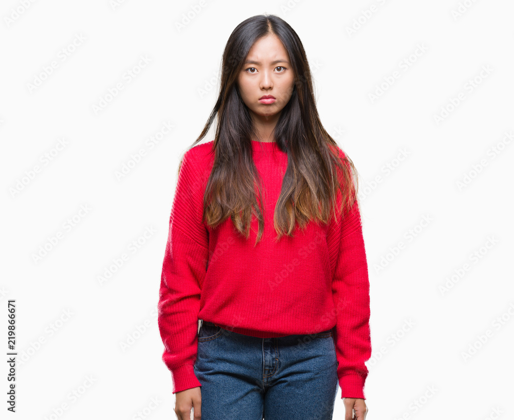 Young asian woman wearing winter sweater over isolated background skeptic and nervous, frowning upset because of problem. Negative person. Young asian woman wearing winter sweater over isolated background skeptic and nervous, frowning upset because of problem. Negative person.