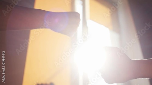 Close up friends hand shaking. Meeting of two friends stand near windows on sunset sunlight sunshine women girl lady people greeting success teamwork friend sun friendship