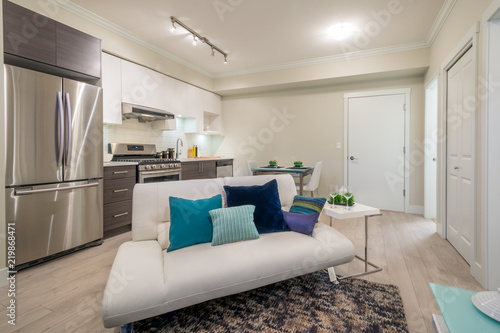 Tablou pe pânză Bright living room with kitchen and dinner table