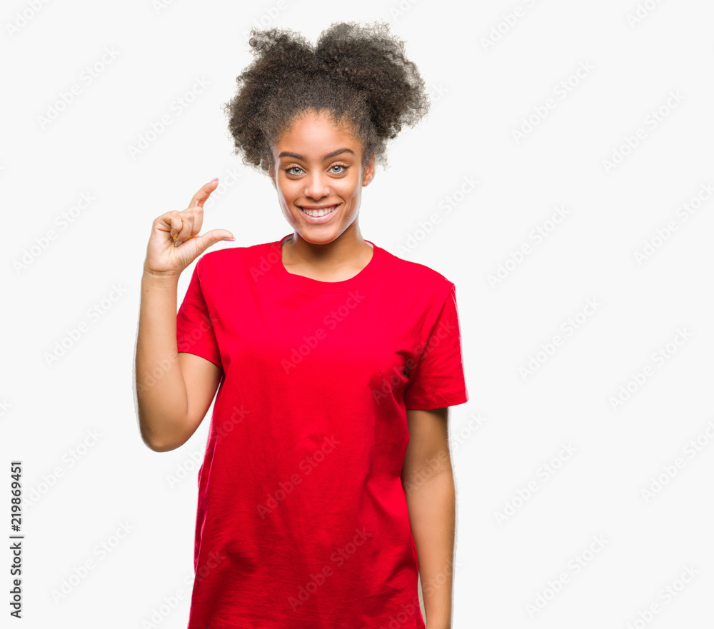 Young afro american woman over isolated background smiling and confident gesturing with hand doing size sign with fingers while looking and the camera. Measure concept. Young afro american woman over isolated background smiling and confident gesturing with hand doing size sign with fingers while looking and the camera. Measure concept.