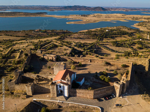 The castle of Mourao with the big lake behind photo