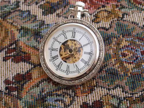 vintage classic pocket watch over vintage fabric