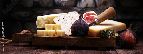 Cheese plate served with figs, various cheese on a platter