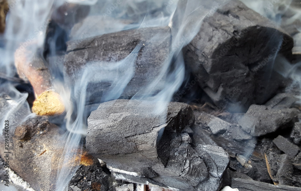 Smoke rising from charcoal used in cooking grill Smoke rising from charcoal used in cooking grill