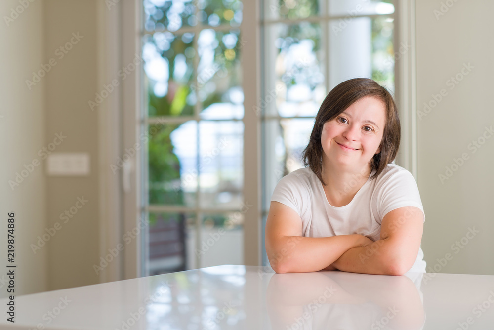 Down syndrome woman at home happy face smiling with crossed arms looking at the camera. Positive person. Down syndrome woman at home happy face smiling with crossed arms looking at the camera. Positive person.