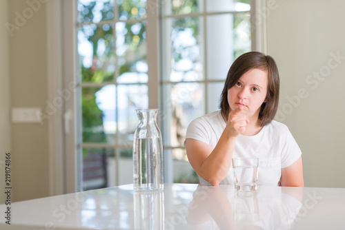 Down syndrome woman at home drinking water pointing with finger to the camera and to you, hand sign, positive and confident gesture from the front Free Download Down syndrome woman at home drinking water pointing with finger to the camera and to you, hand sign, positive and confident gesture from the front - GFXLoad
