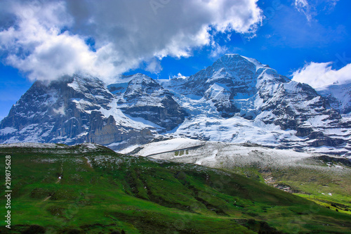 mountains and fields and blue sky of the Switzerland