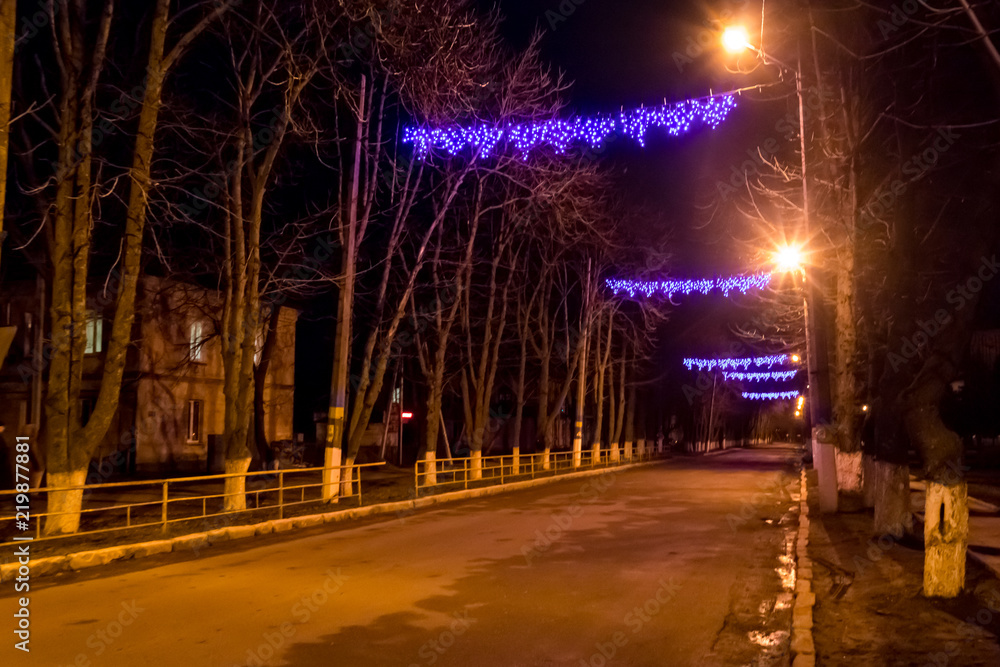 Night city road decorated by illumination for Christmas and New Year holidays