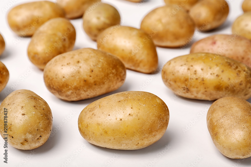 Fresh organic potatoes on white background, closeup view Fresh organic potatoes on white background, closeup view