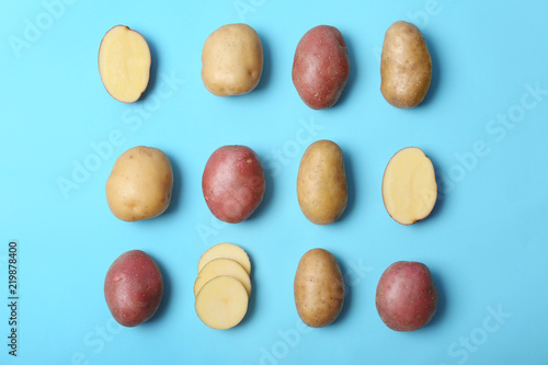 Flat lay composition with fresh organic potatoes on color background