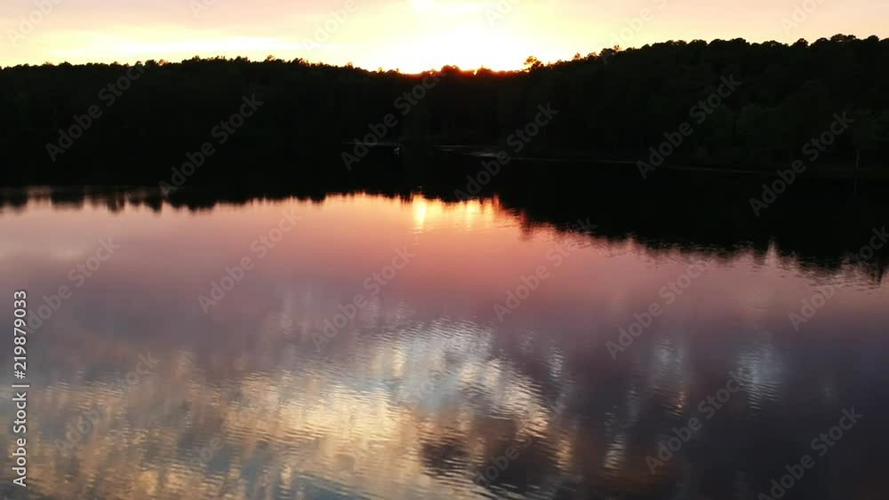 Tilt up aerial, sunset over lake Tilt up aerial, sunset over lake