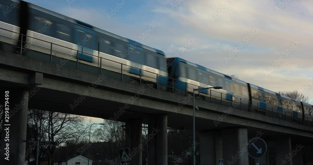 Stockholm subway passing by on a bridge at sundown Stockholm subway passing by on a bridge at sundown