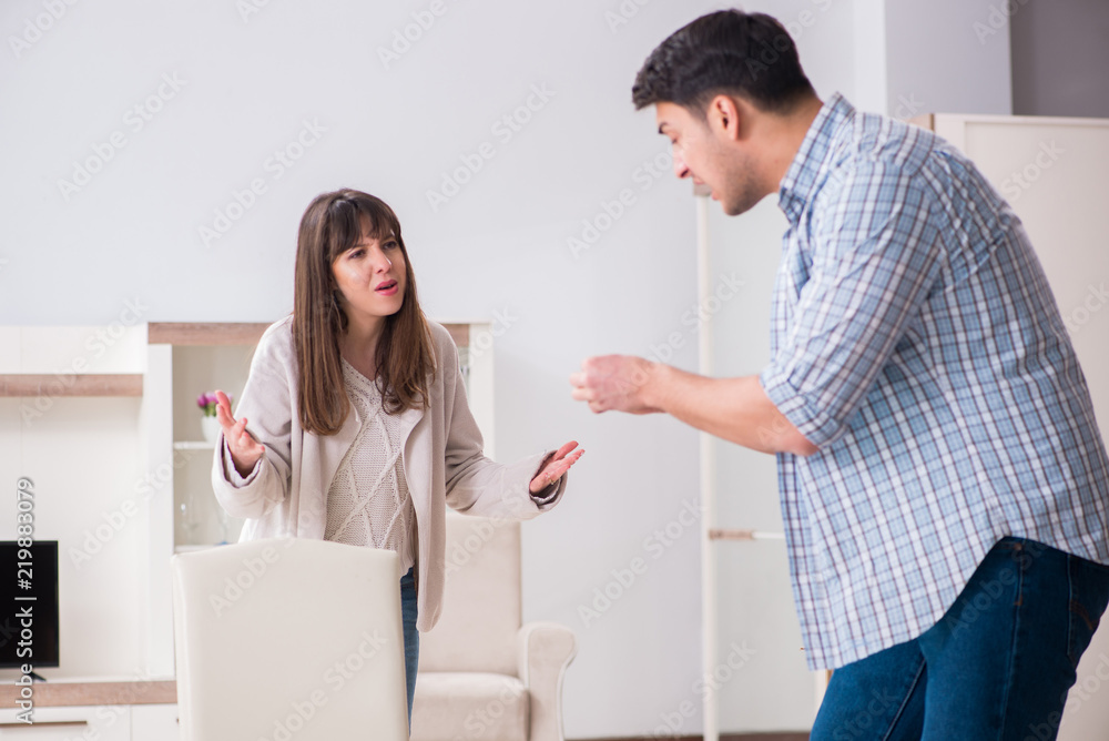 Fototapeta premium Woman evicting man from house during family conflict