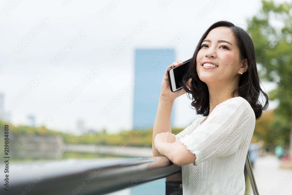 attractive asian woman relaxing in park