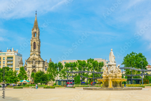 Church of Sainte Perpetue and fountain Pradier in Nimes, France photo