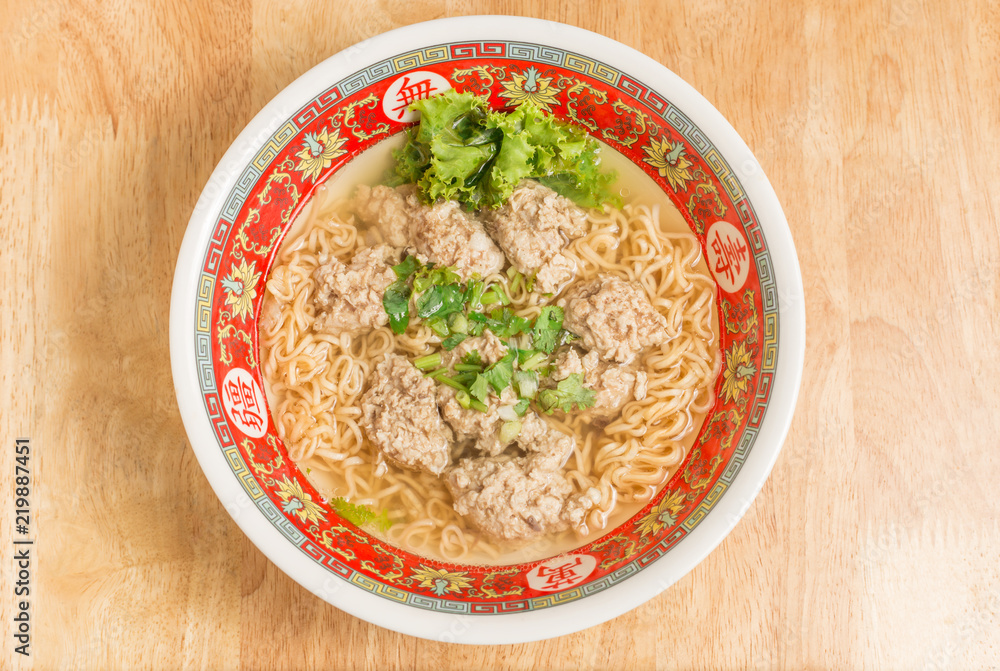 Close up of Instant noodle with meat ball and green Coriander on wood table Close up of Instant noodle with meat ball and green Coriander on wood table