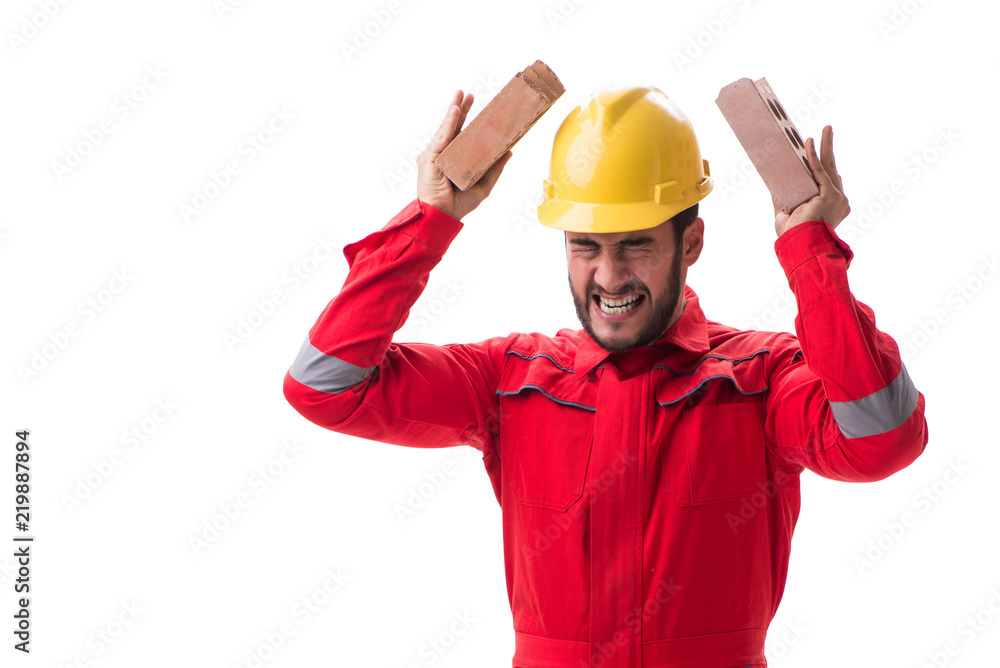 Angry builder breaking bricks isolated on white Angry builder breaking bricks isolated on white