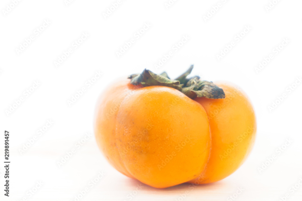 Persimmon on a white background, persimmon orange in front view Persimmon on a white background, persimmon orange in front view