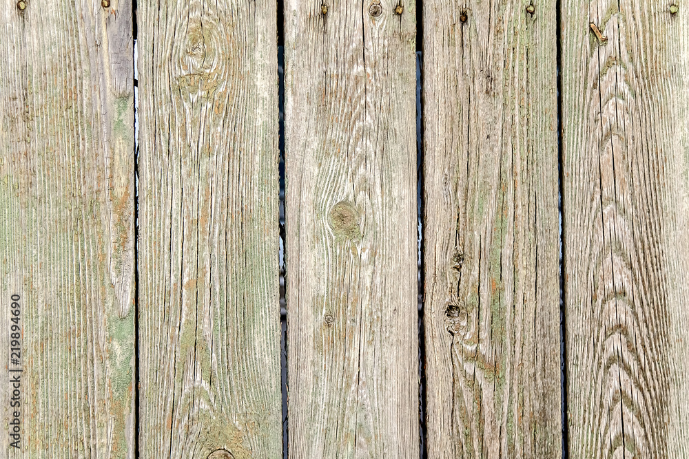 Naklejka premium Old wooden planks in a fence as an abstract background