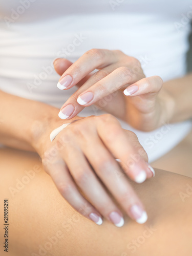 Young woman applying hand cream  closeup view