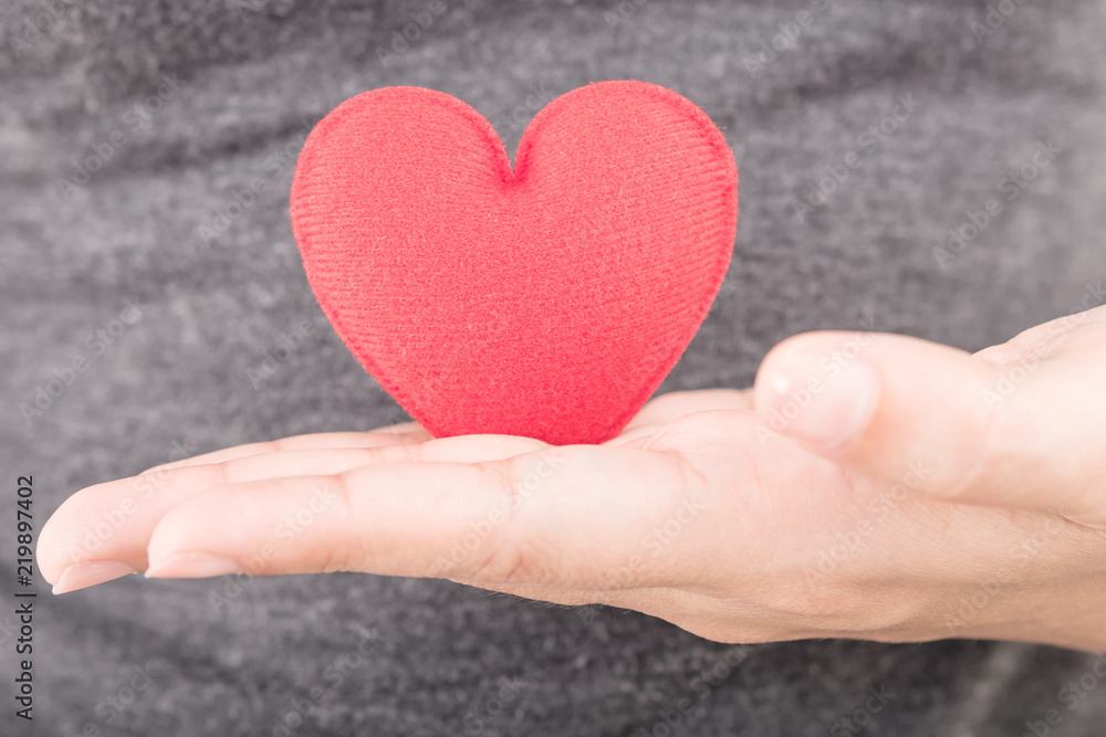 red heart in human hand with dramatic tone red heart in human hand with dramatic tone