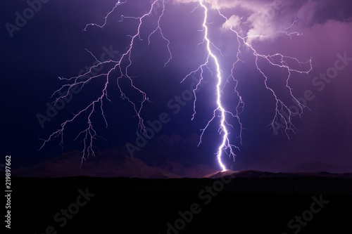 Lightning bolt strike on a mountain during a storm