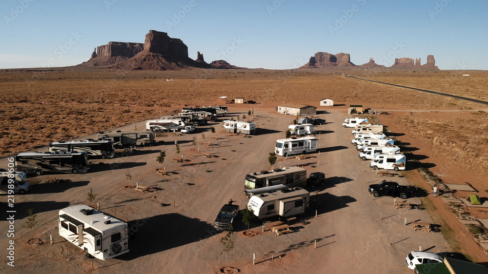 Foto Stock Utah, United States - July 9, 2018: RV park (campground) near  the Oljato–Monument Valley, Utah. Aerial view, from above, drone shooting.  Arizona - Utah border. Sunset | Adobe Stock