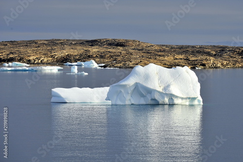 Icebergs in the background of picturesque Greenland mountains.