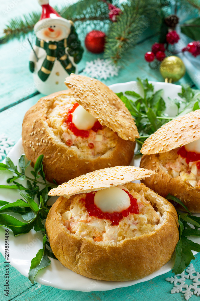 Festive appetizer on the Christmas table. Bun stuffed with shrimp salad and red кавиар close-up. Festive appetizer on the Christmas table. Bun stuffed with shrimp salad and red кавиар close-up.