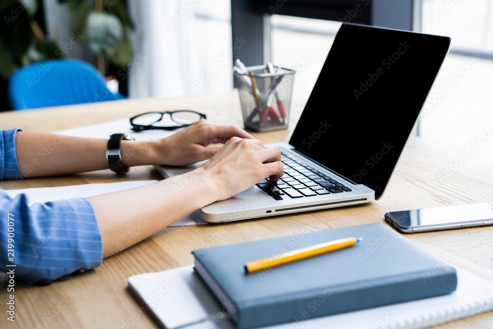 Detail of woman's hand typing on a laptop keyboard. Detail of woman's hand typing on a laptop keyboard.