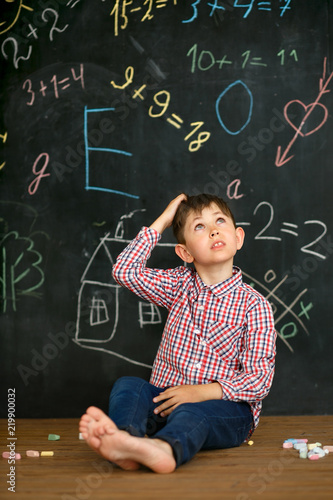 A small student solves a difficult task. photo