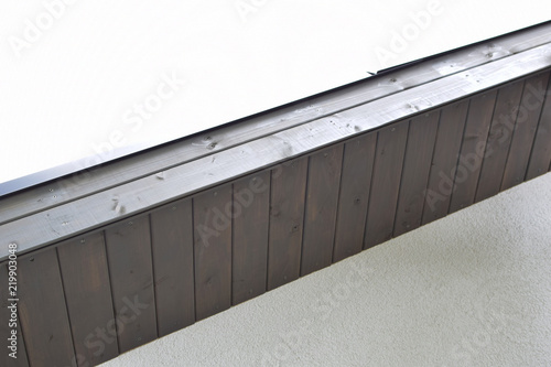 Foto Fragment of just installed grey brown wooden roof eaves on clear sky background with copy space for text