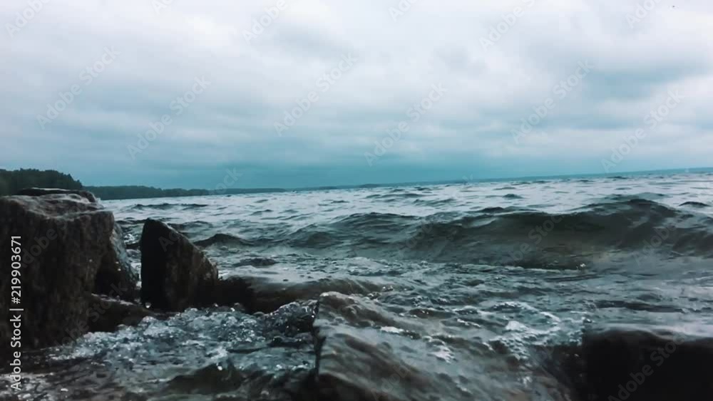 Waves breaking on sharp rocks. Mountain lake Waves breaking on sharp rocks. Mountain lake