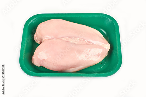 Raw chicken breast in a tray on a white background.