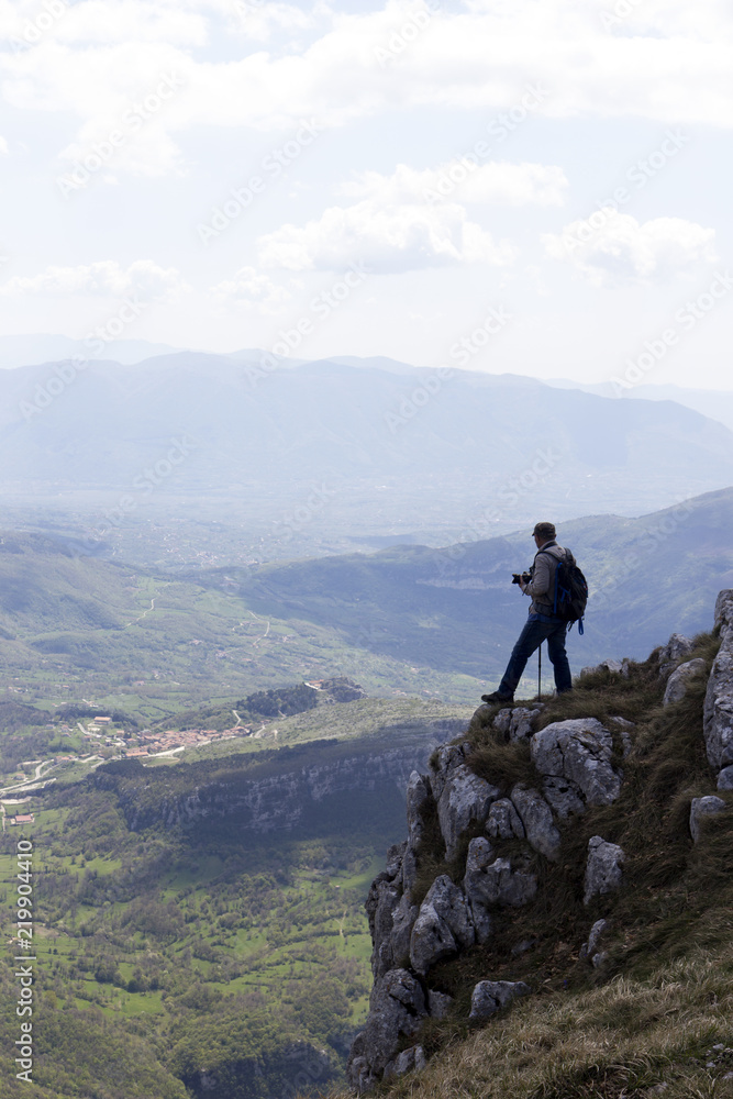 Fototapeta premium Hiker on the summit of a mountain