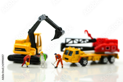 Fototapeta Naklejka Na Ścianę i Meble -  Miniature people : worker team for building home ,Image use for construction, business or Building and Code Staff Appreciation Day concept,house repair or home renovating
