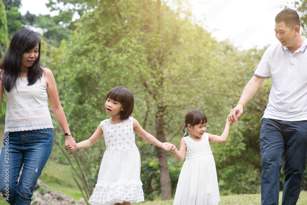 Asian family hold hands and walking at outdoor park. Asian family hold hands and walking at outdoor park.