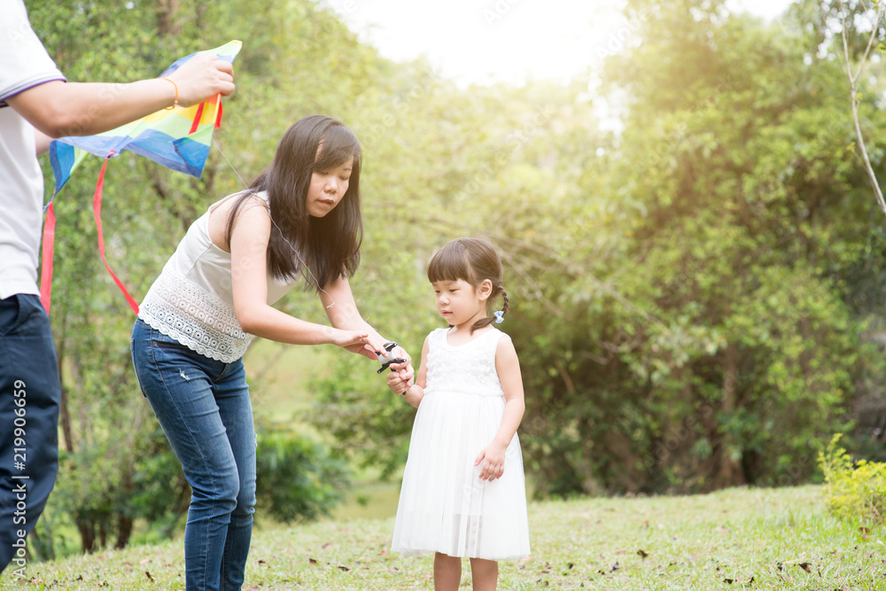 Asian family flying kite at outdoor park. Asian family flying kite at outdoor park.