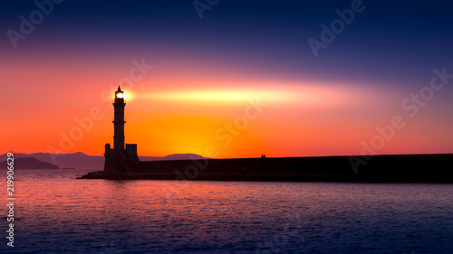 Obraz na płótnie A beautiful night sky behind a shining lighthouse. Chania, Crete, Greece w salonie