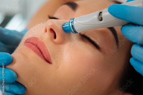 Modern cosmetology. Close up of a modern device for hydrafacial procedure used for face cleansing photo