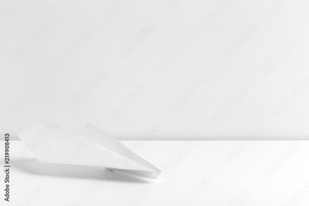 Flat lay of white paper plane on white color background Flat lay of white paper plane on white color background