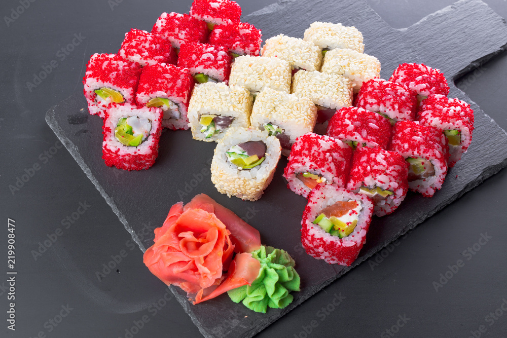 Japanese restaurant, sushi roll on black slate plate. Japanese restaurant, sushi roll on black slate plate.