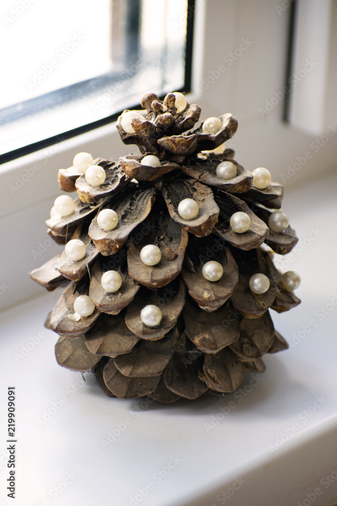 Pine cone in the form of a New Year tree. Christmas tree. Pine cone decorated with pearls. Pine cone in the form of a New Year tree. Christmas tree. Pine cone decorated with pearls.