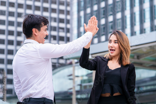 Business lover couple is hi five for success in modern city photo