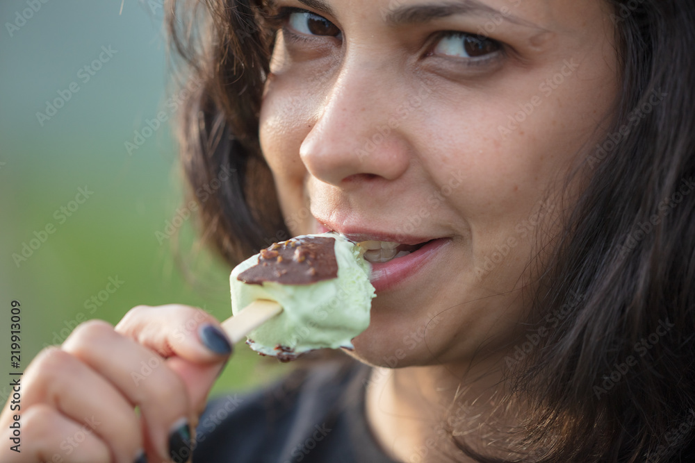 The girl is eating ice cream on a stick The girl is eating ice cream on a stick