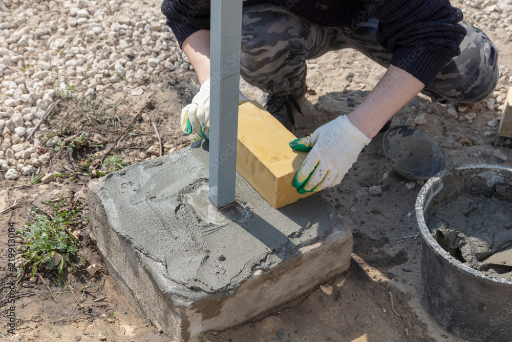 The worker lays bricks on the construction site The worker lays bricks on the construction site