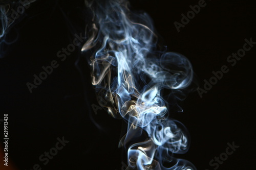 pretty abstract light blue smoke on heavy black background.