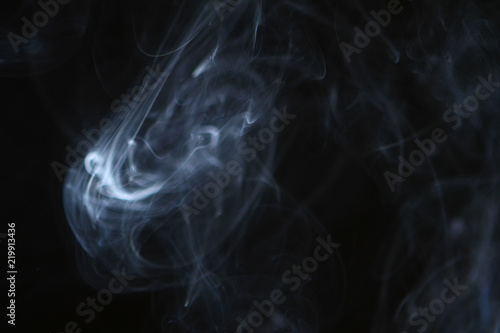 amazing flowing contrast bright smoke on the dark background.